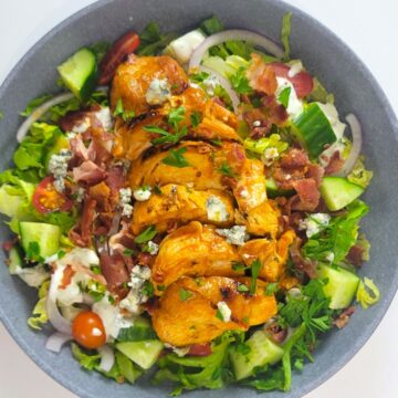 Buffalo Chicken on a bed of lettuce with blue cheese dressing.