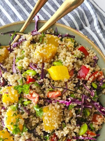 This is an image of an Autumn Quinoa Bowl with serving spoons.
