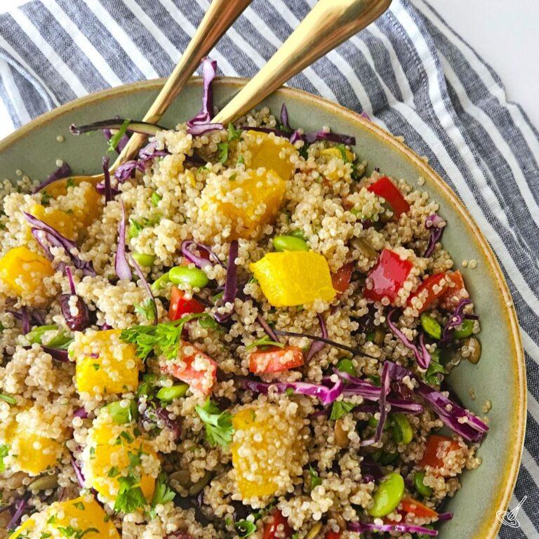 This is an image of an Autumn Quinoa Bowl with serving spoons.