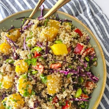 This is an image of an Autumn Quinoa Bowl with serving spoons.