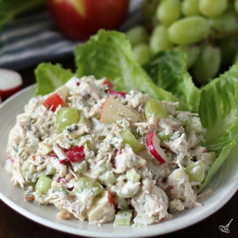 Waldorf Chicken Salad on a bed of lettuce.