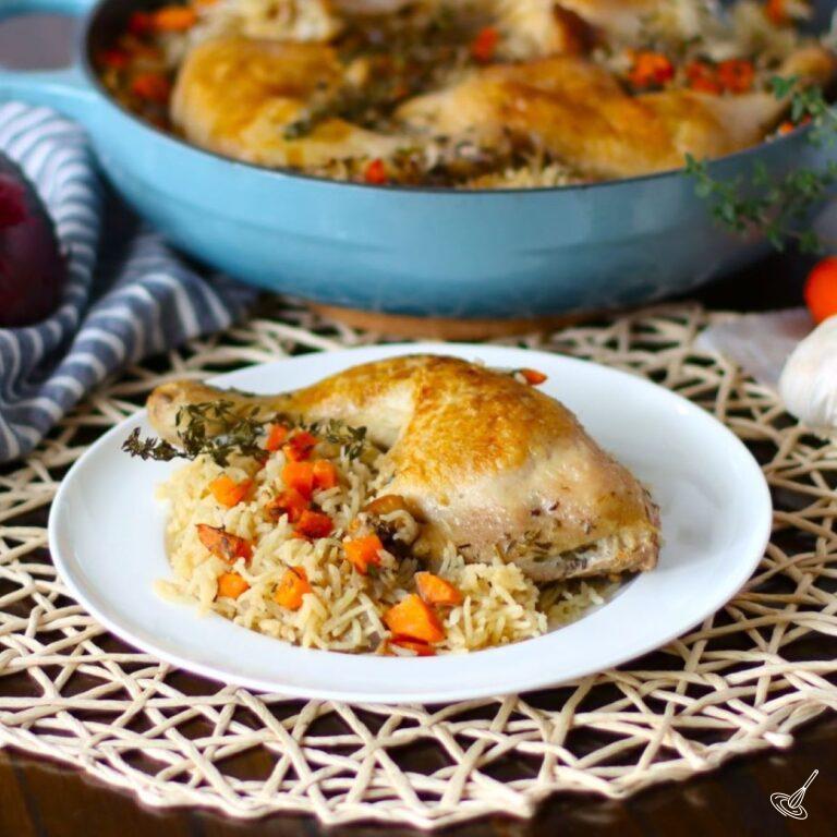 A cooked quarter chicken on a plate with rice.