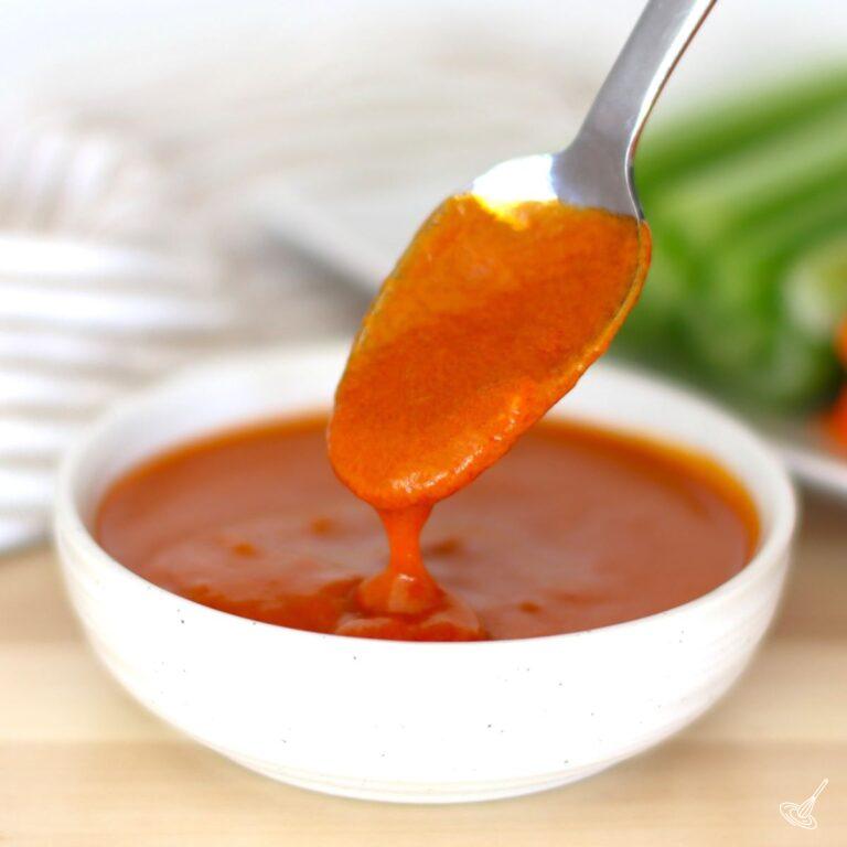 Mild Buffalo Sauce with a spoon.