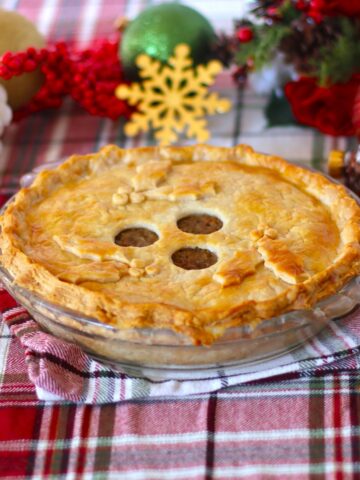 Tourtière Meat Pie on a holiday themed table.