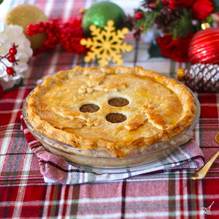 Tourtière Meat Pie on a holiday themed table.