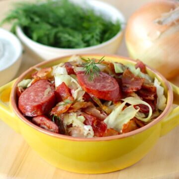 Fried Cabbage with bacon and sausage in a bowl.