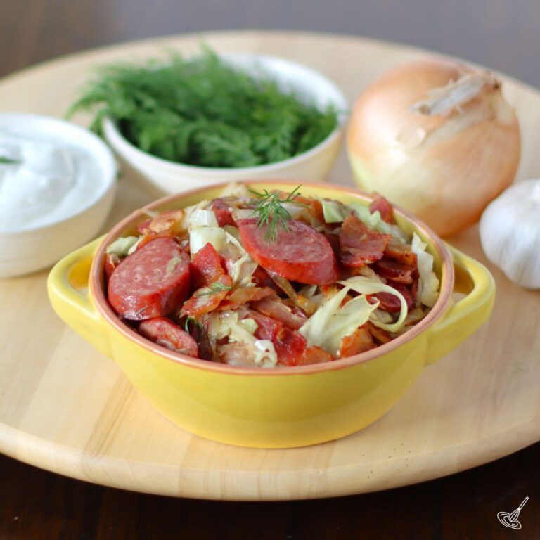 Fried Cabbage and sausage in a serving dish.