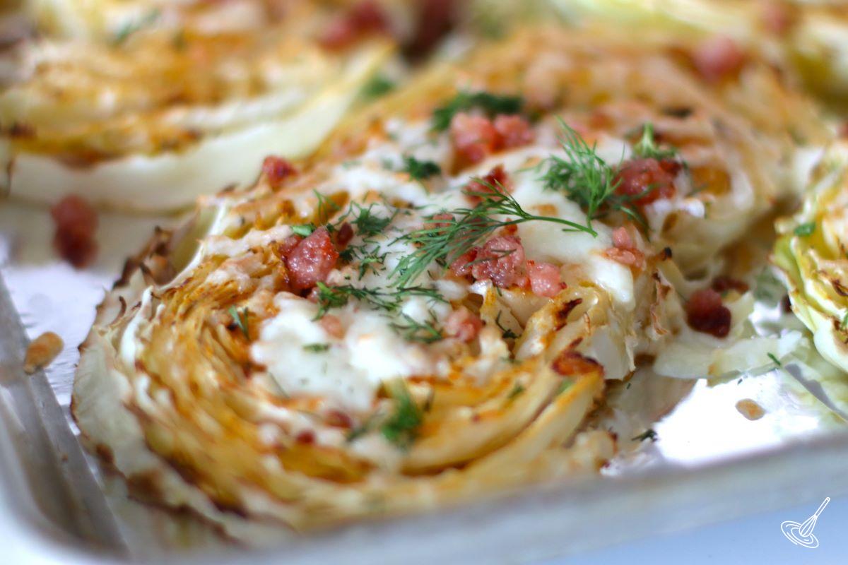 Slices of roasted cabbage on a baking sheet.