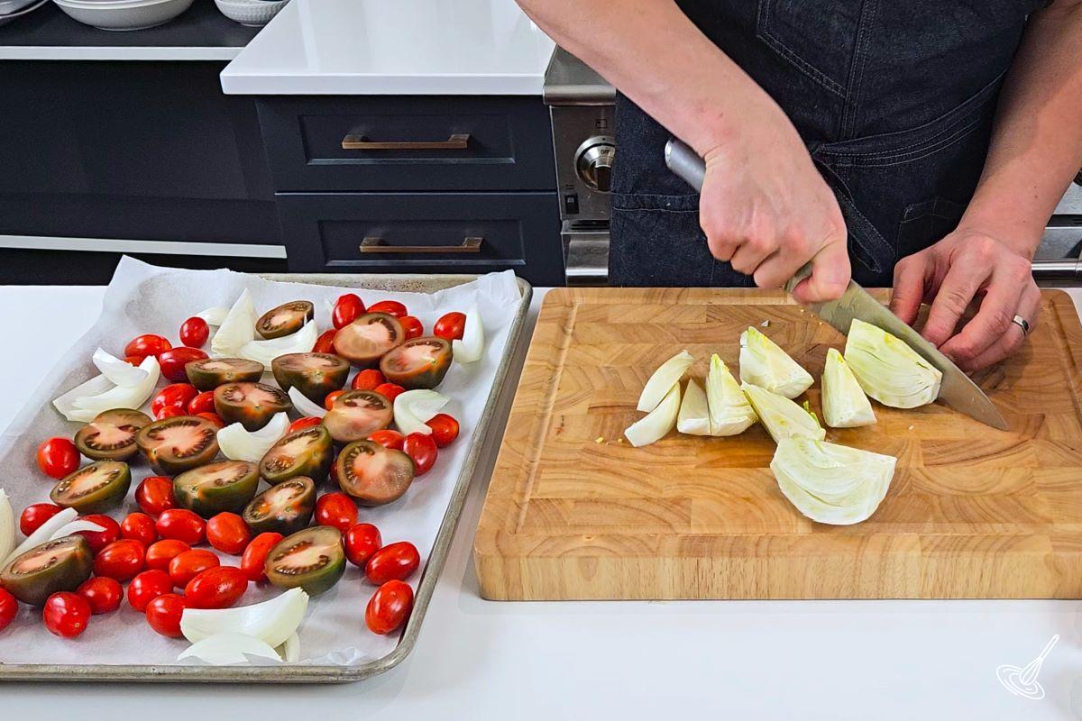 Someone cutting a fennel bulb in sections.