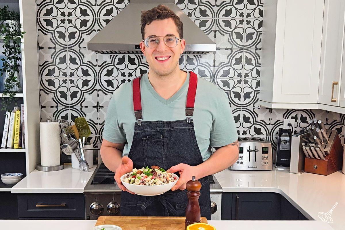 Someone holding a bowl of Chicken Wild Rice Salad. 