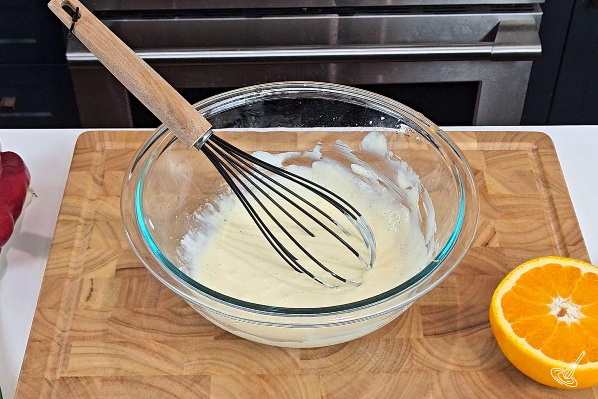 Creamy orange dressing in a large bowl. 
