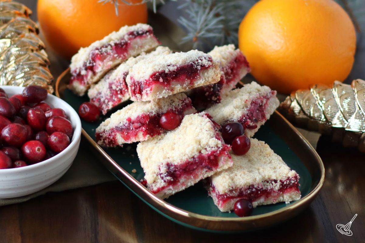 Cranberry Shortbread Bars stacked up on a serving platter.