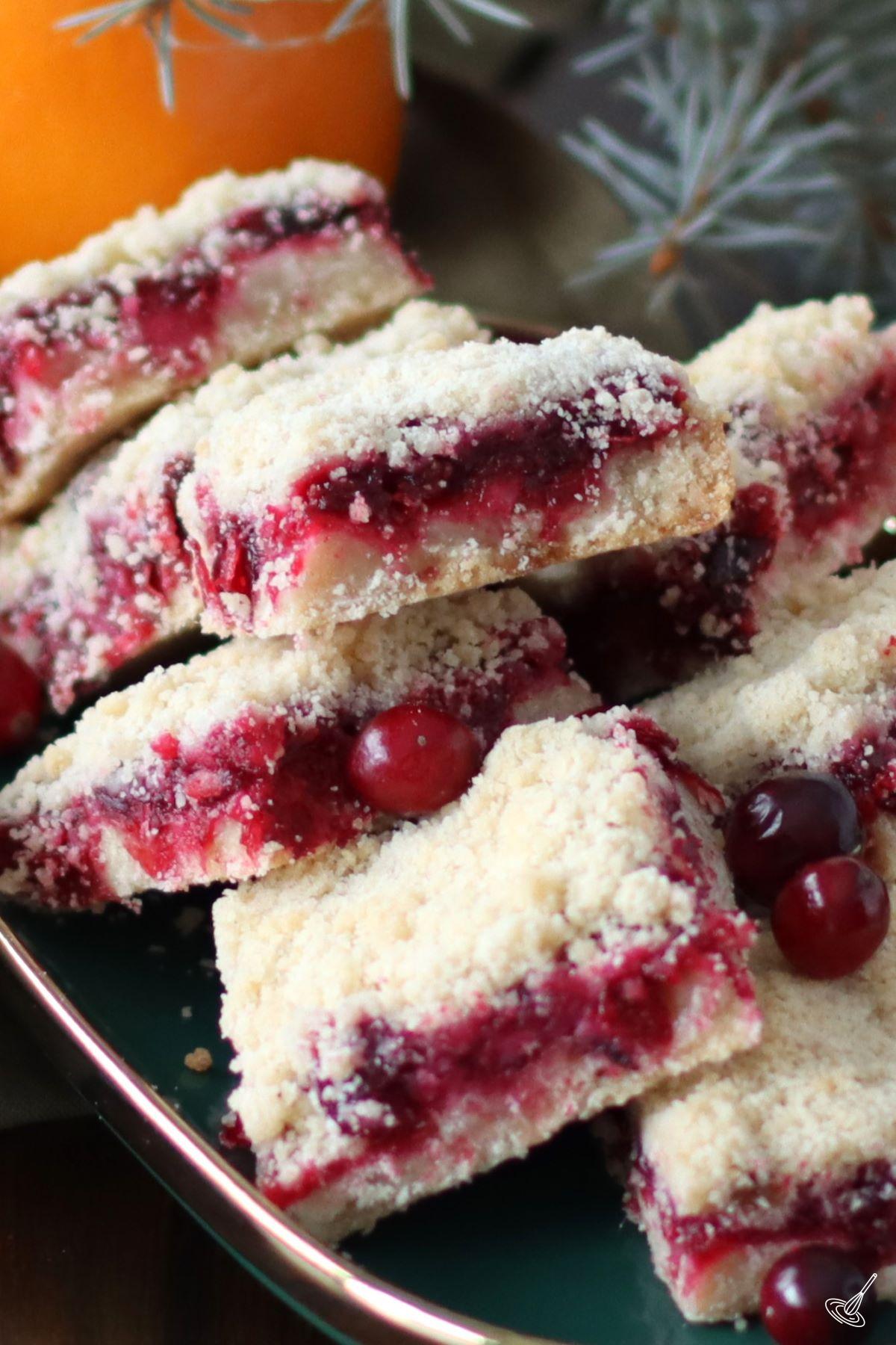 Cranberry Shortbread Bars stacked up on a platter. 