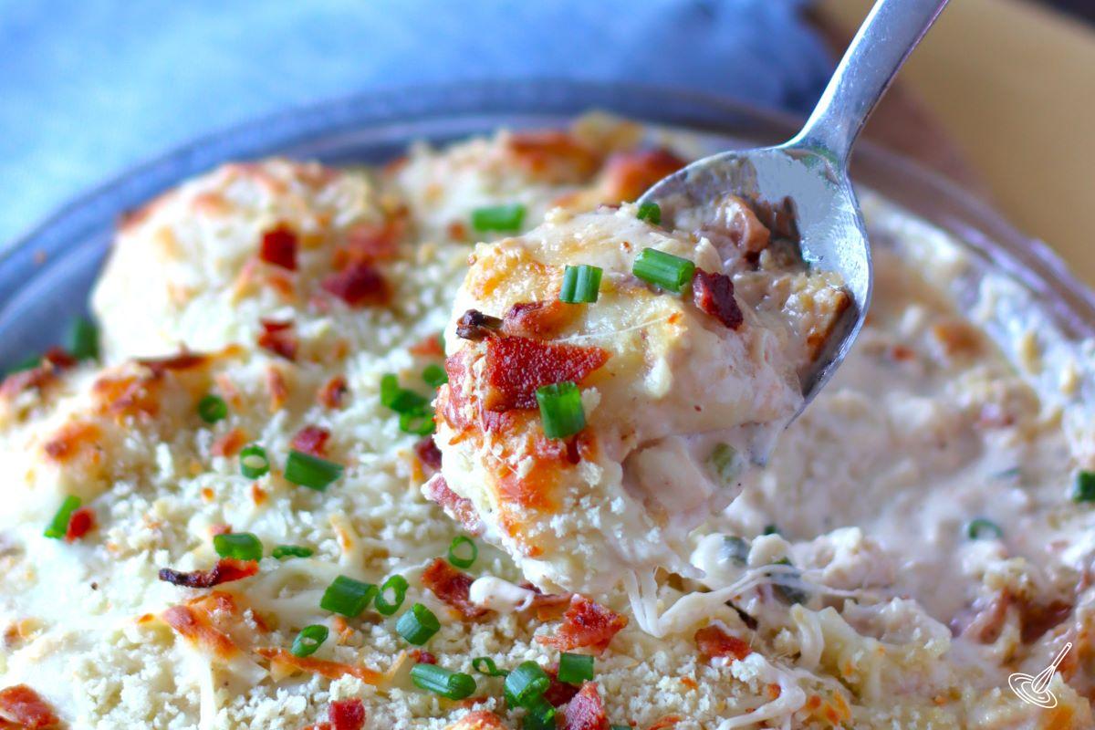 Someone holding up a spoonful of Crack Chicken Pierogi Casserole. 