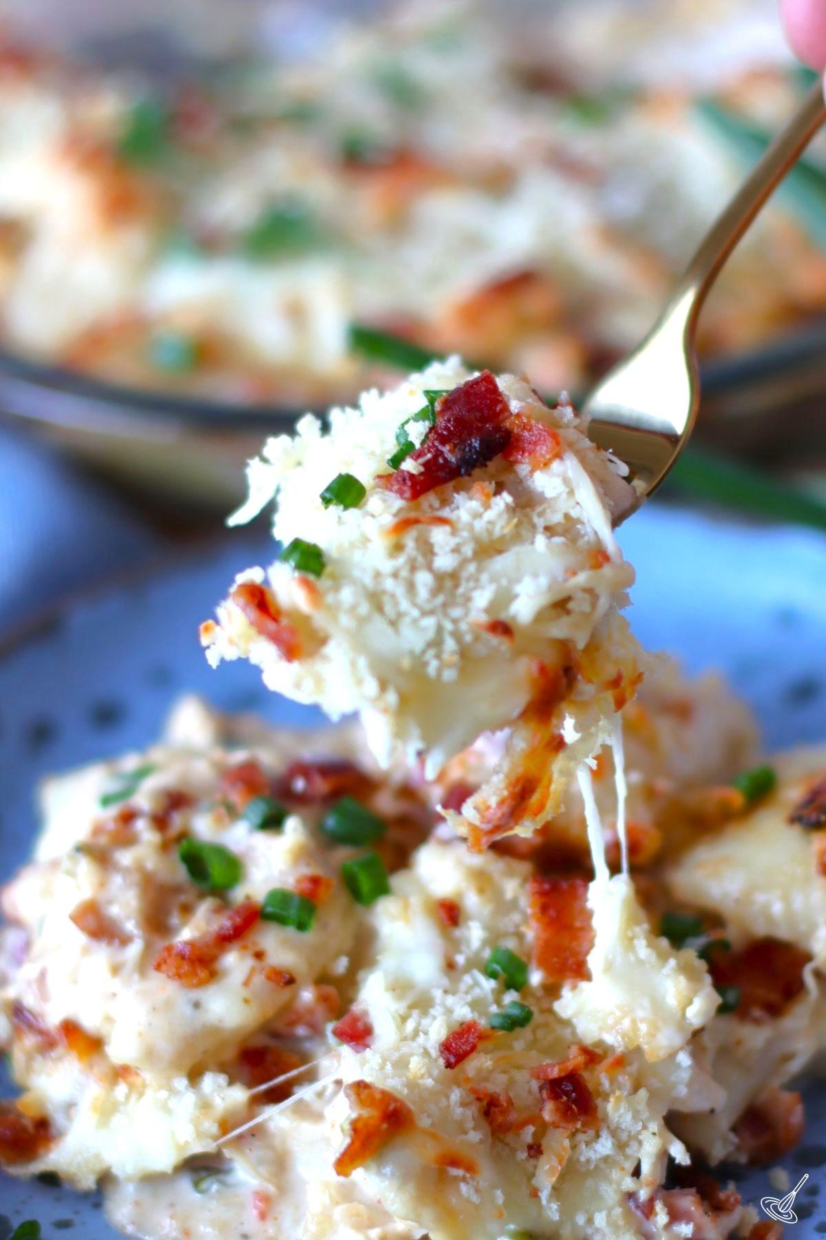 Someone holding up a fork of Crack Chicken Pierogi Casserole. 