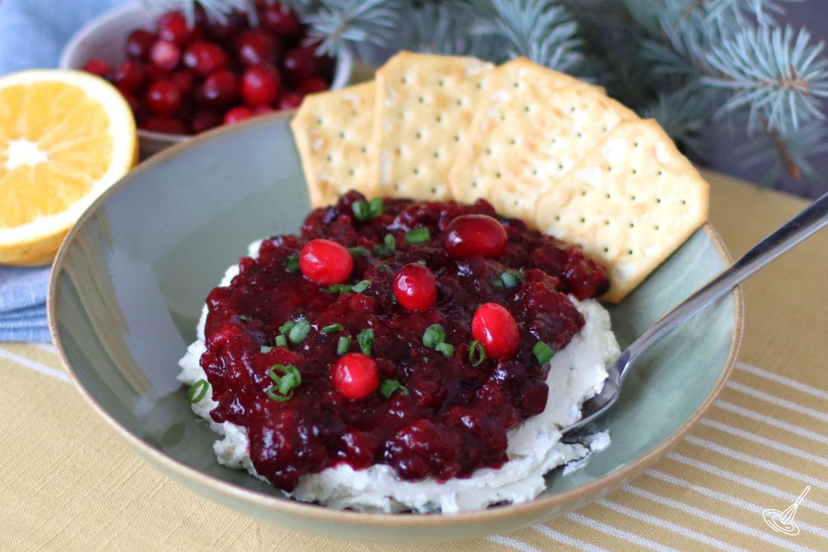 Creamy Cranberry Jalapeno Dip in a bowl with crackers. 