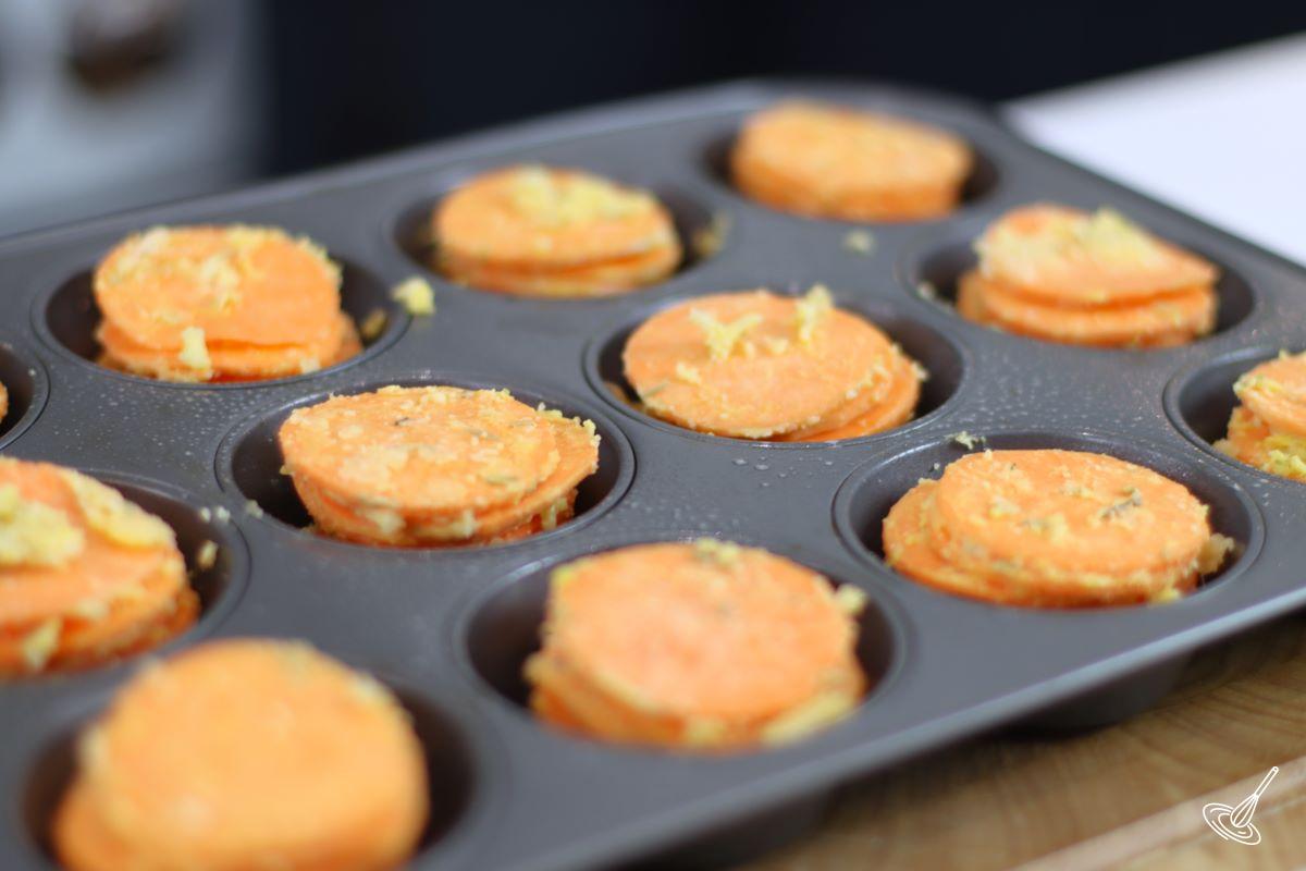 Garlic Butter Sweet Potato Stacks in a muffin tin.