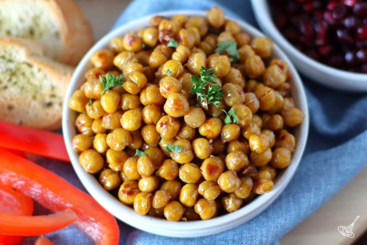 Roasted Chickpeas in a bowl with vegetables and crostini on the side. 