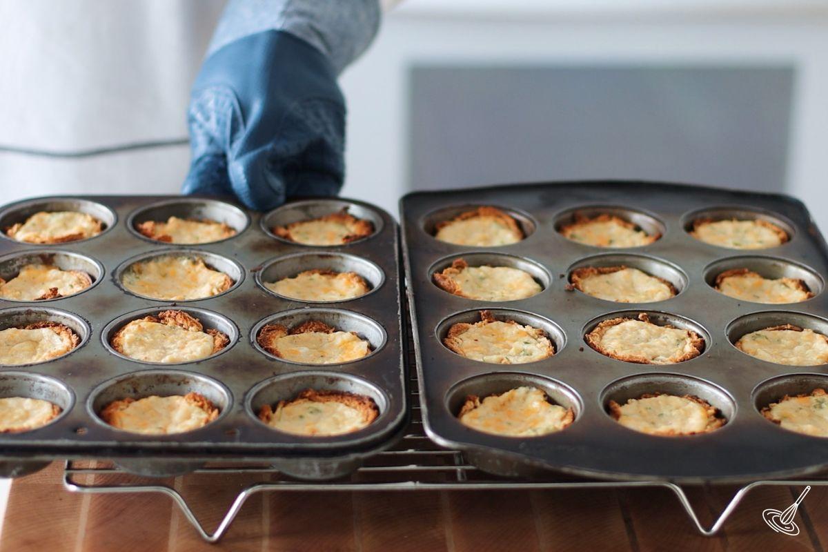 Cooked crab puffs on a cooling rack.