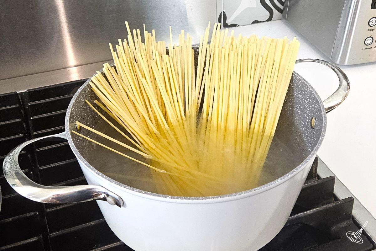 Pasta cooking in a large pot of boiling water.