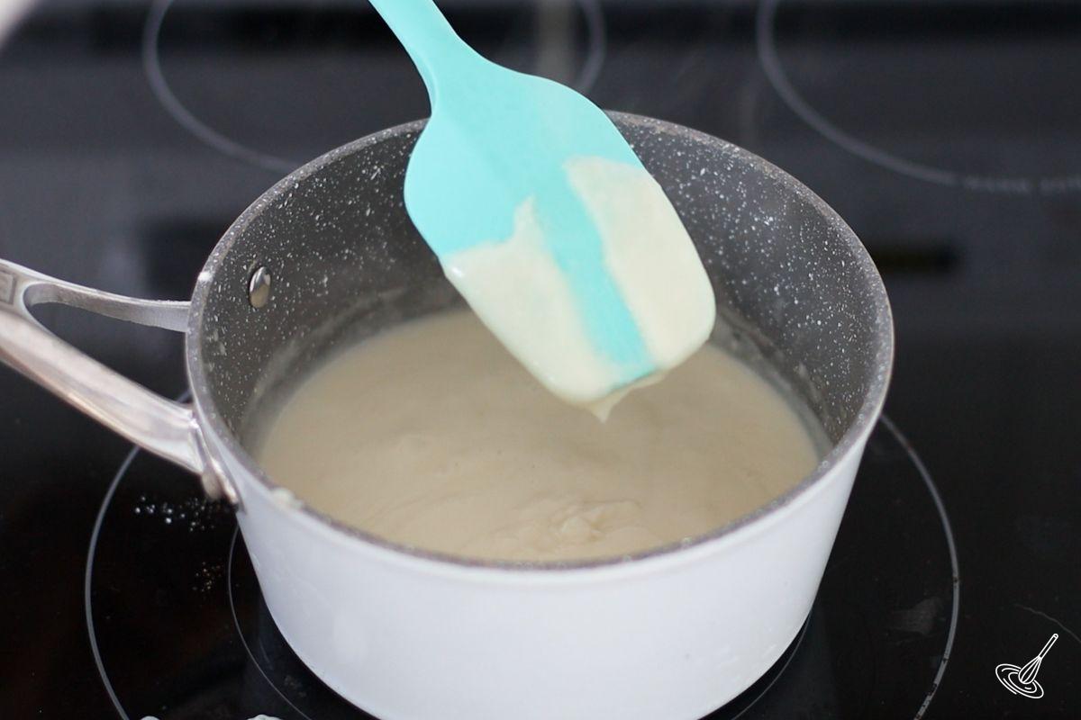 A rubber spatula coated in a bechamel sauce.