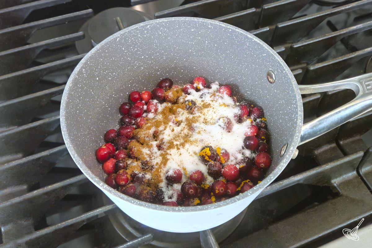 Fresh cranberries and spices in a medium sauce pan. 