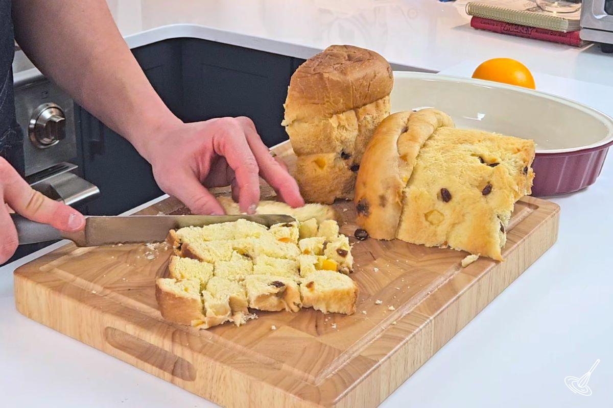 Someone cutting a Panettone into cubes.