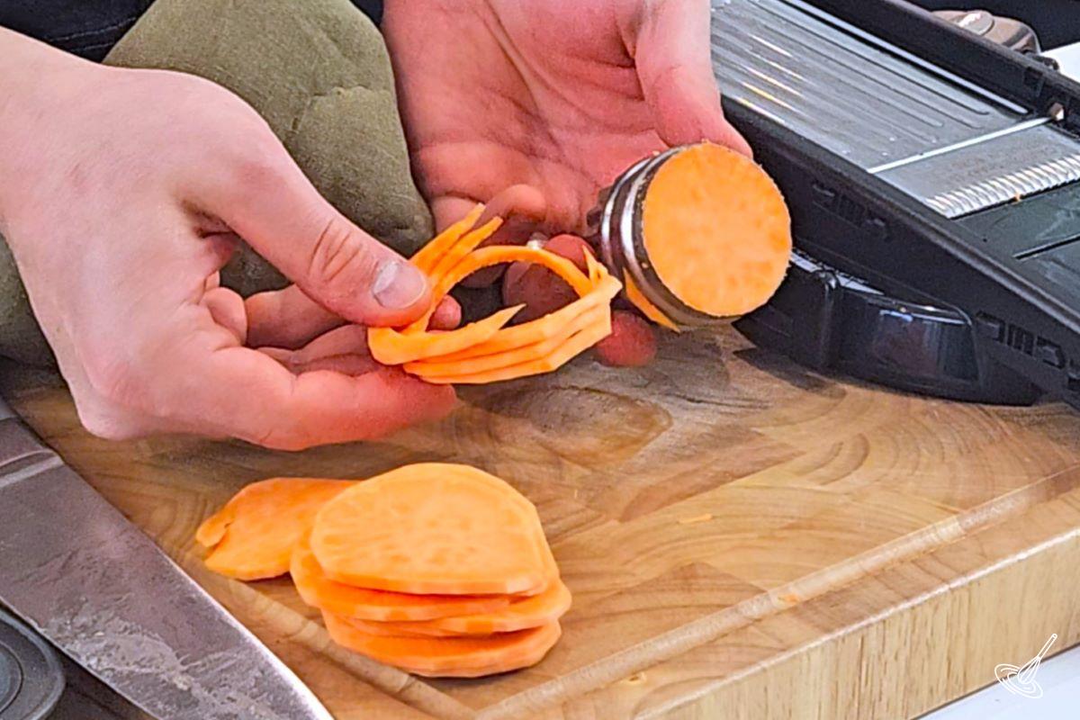 Someone using a cookie cutter to cut rounds in the