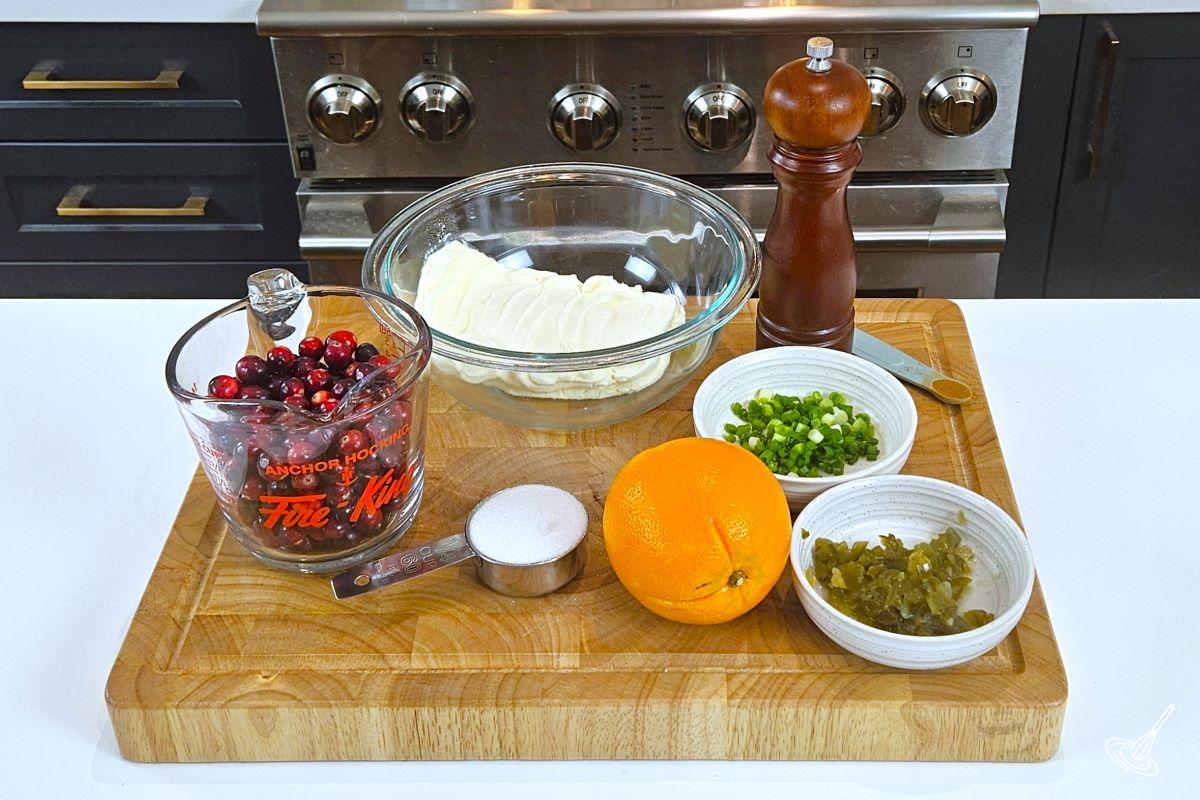 A selection of ingredients on a wooden cutting board. 
