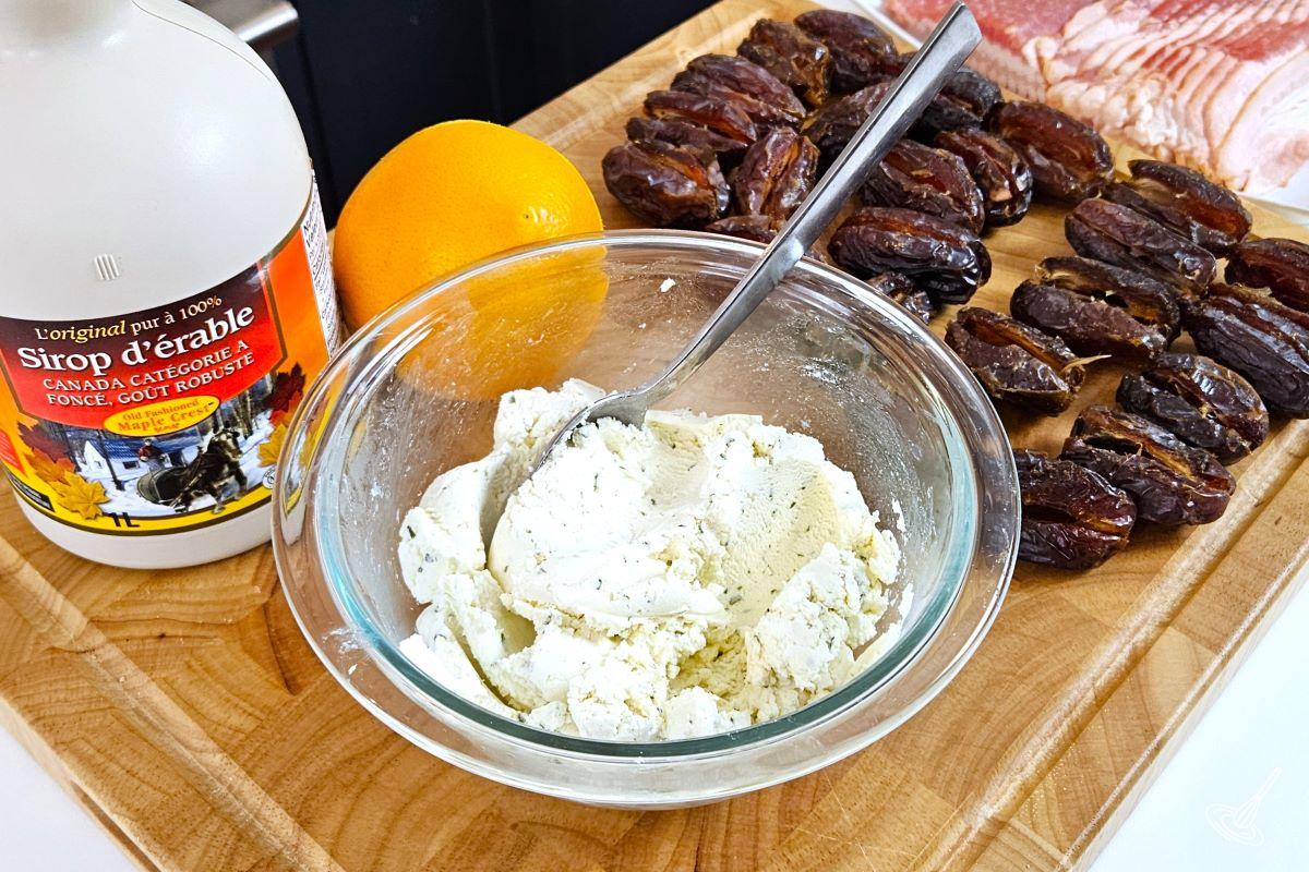 A small bowl of goat cheese with maple syrup and an orange on the side.