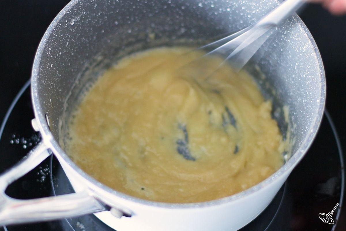 Someone whisking a roux.