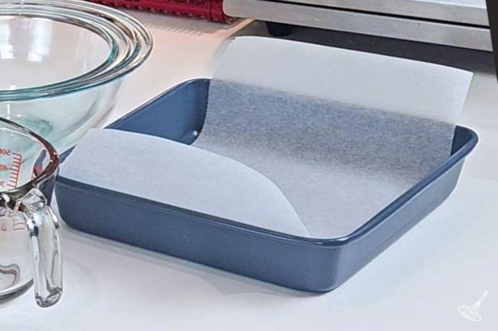 A baking pan, lined with a piece of parchment paper. 
