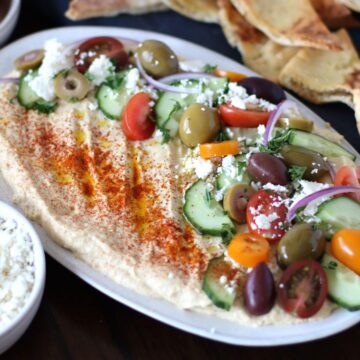 Greek Loaded Hummus on a platter.