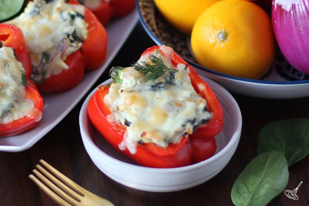 A stuffed bell pepper in a white dish.