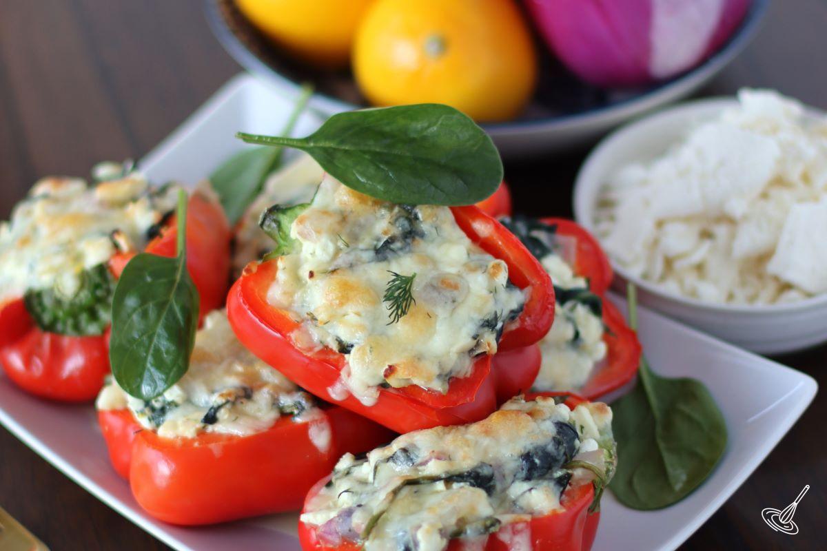 A stack of Spanakopita Stuffed Peppers on a white platter.