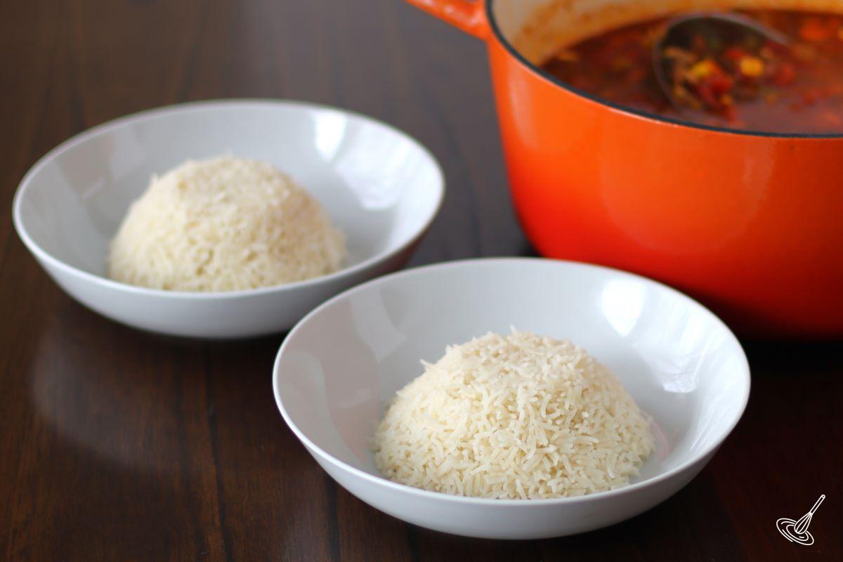 Two soup bowls containing a scoop of rice. 