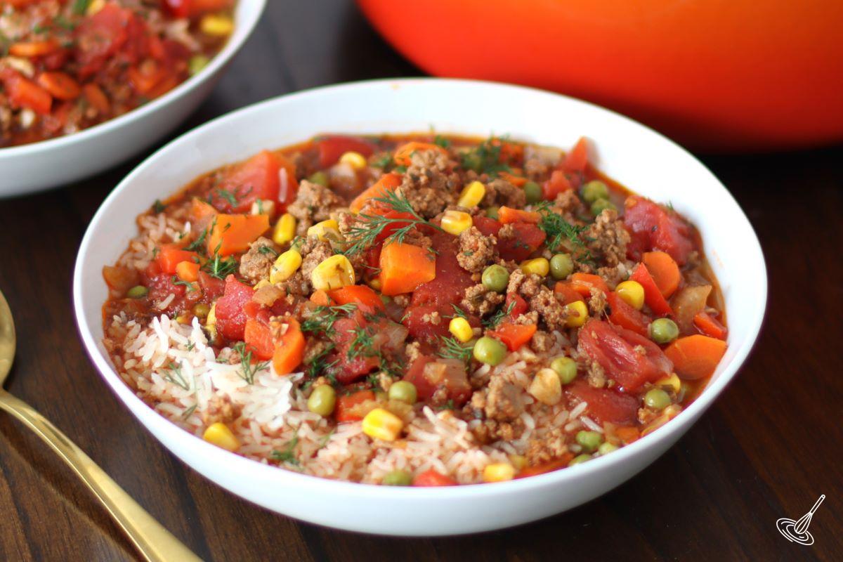 A large white bowl of Beef and Rice Soup.