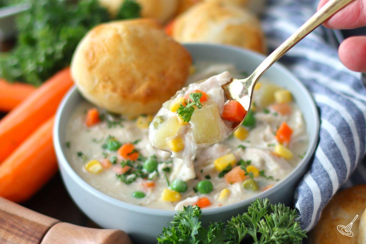 Someone taking a spoonful of Crustless Chicken Pot Pie. 