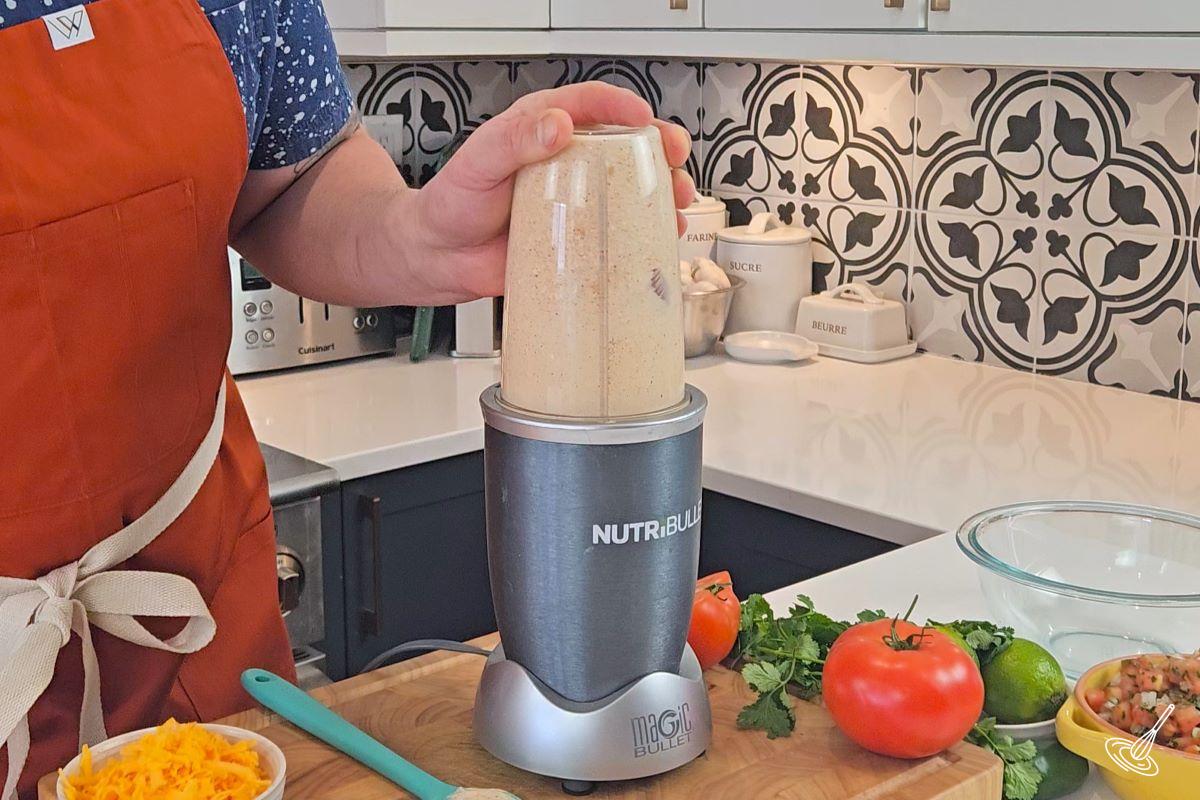 Someone blending cottage cheese in a blender.