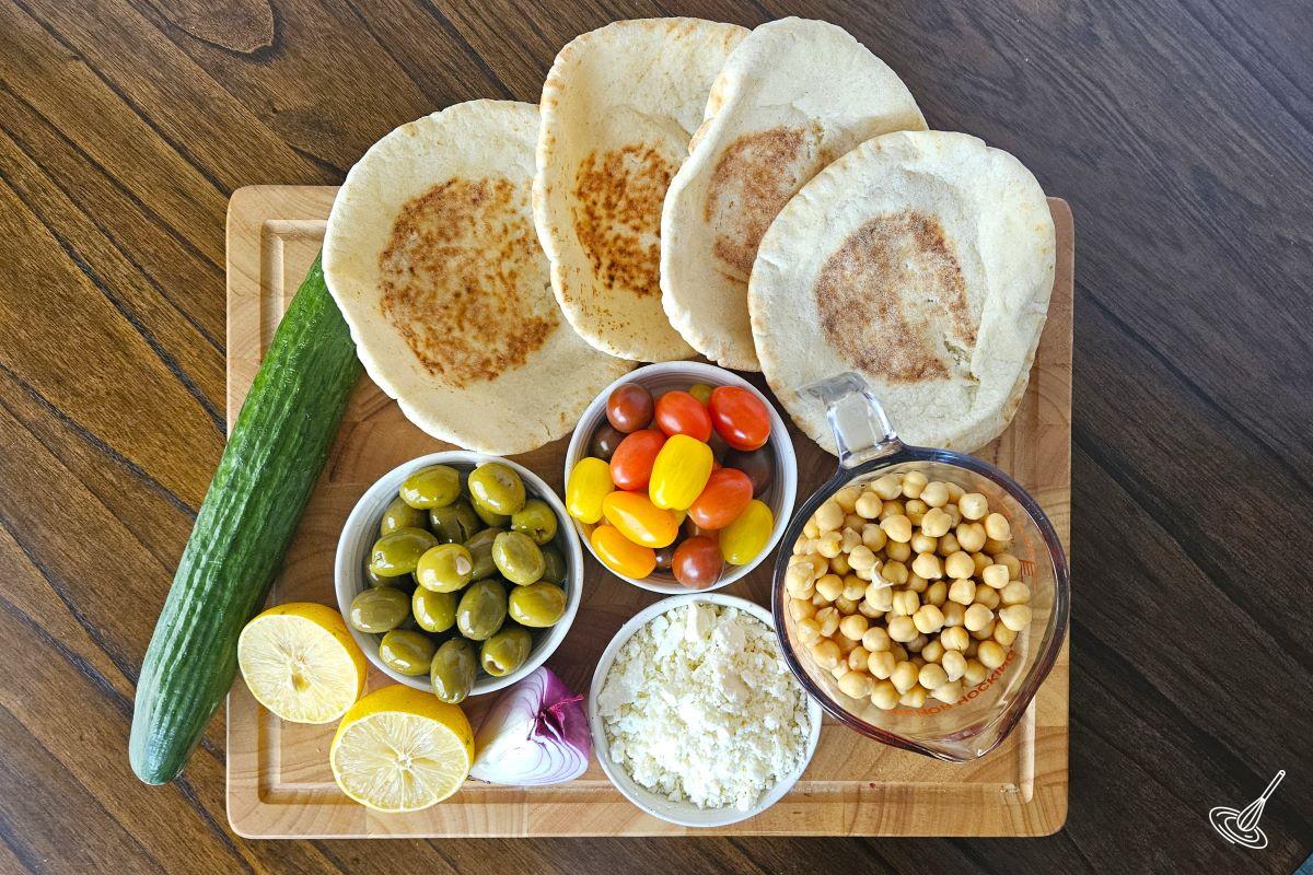 Ingredients to make hummus on a cutting board.