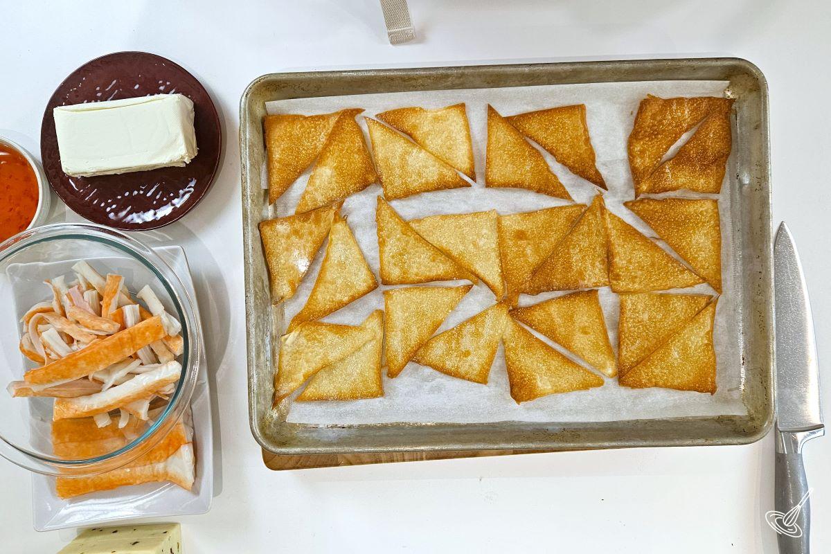 A baking tray with baked wonton chips.
