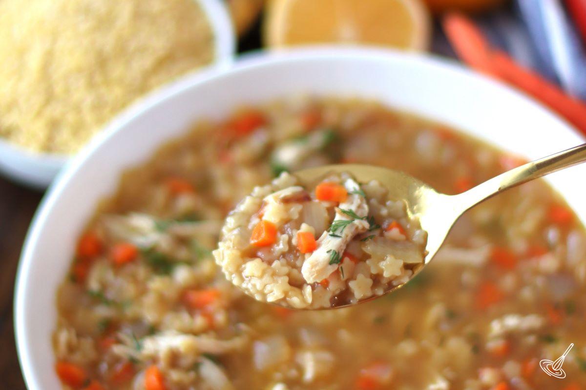 Someone taking a spoonful of soup.