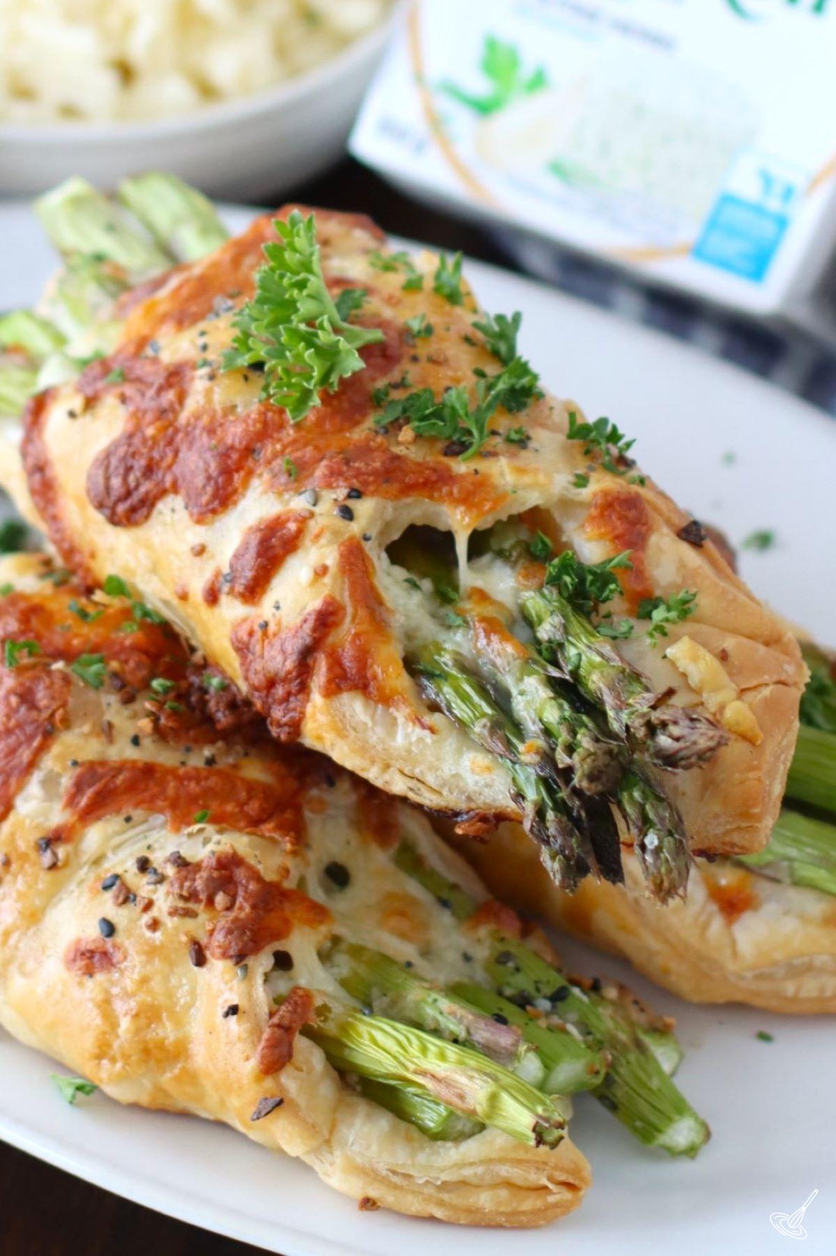 A stack of Alfredo Asparagus Bundles on a plate. 