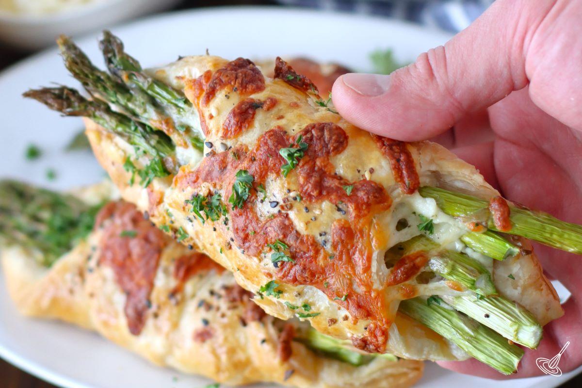 Someone holding an Alfredo Asparagus Bundle. 