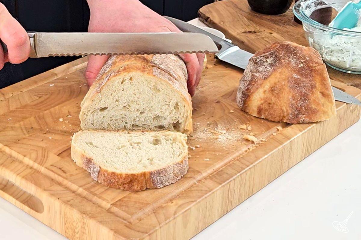 Someone slicing bread.