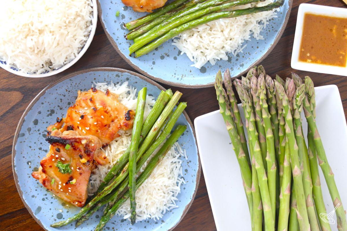 Sheet Pan Miso Honey Chicken served on plated with asparagus and rice.