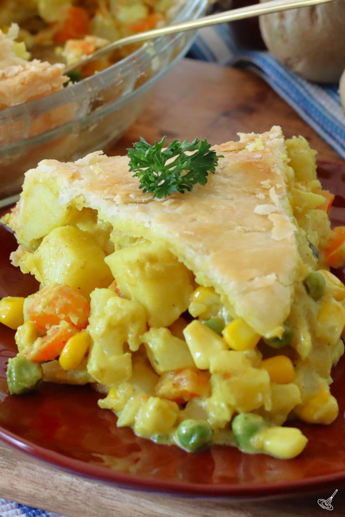 A piece of Curry Pot Pie on a plate.