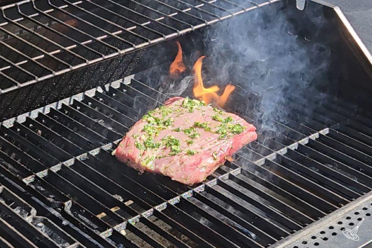 A chimichurri steak being grilled. 
