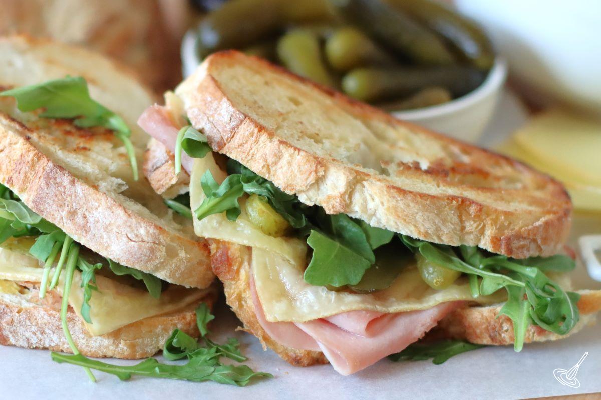 Two raclette sandwiches on a platter.