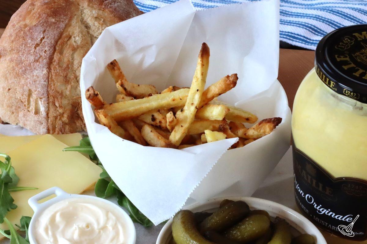 A bowl of homemade fries with a mayonnaise dipping sauce. 
